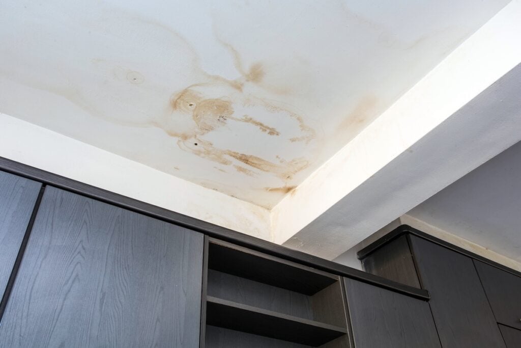 Roof leakage, water damaged ceiling roof and stain on ceiling close-up leaky roof