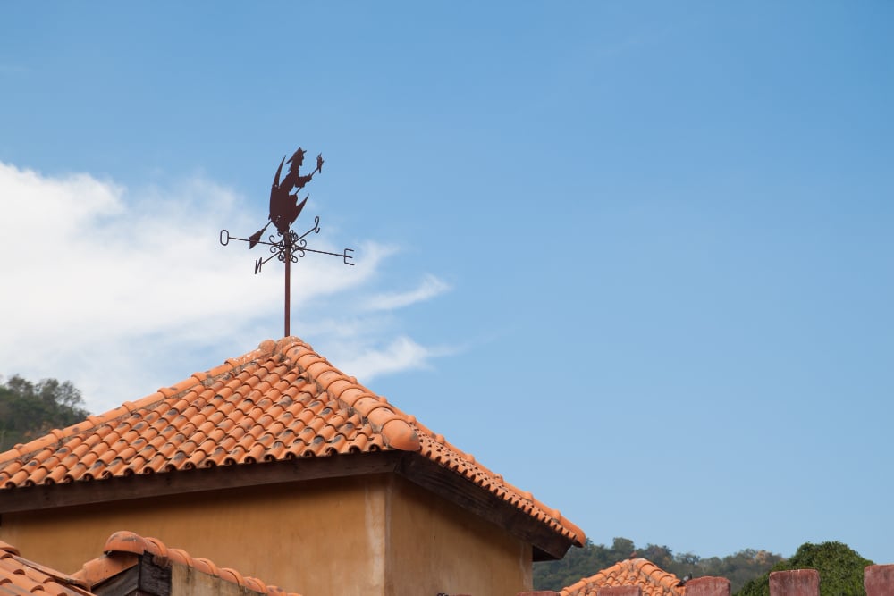 a weather vane on top of a roof