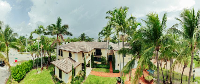 Tropical house surrounded by palm with roof in west palm beach fl trees.