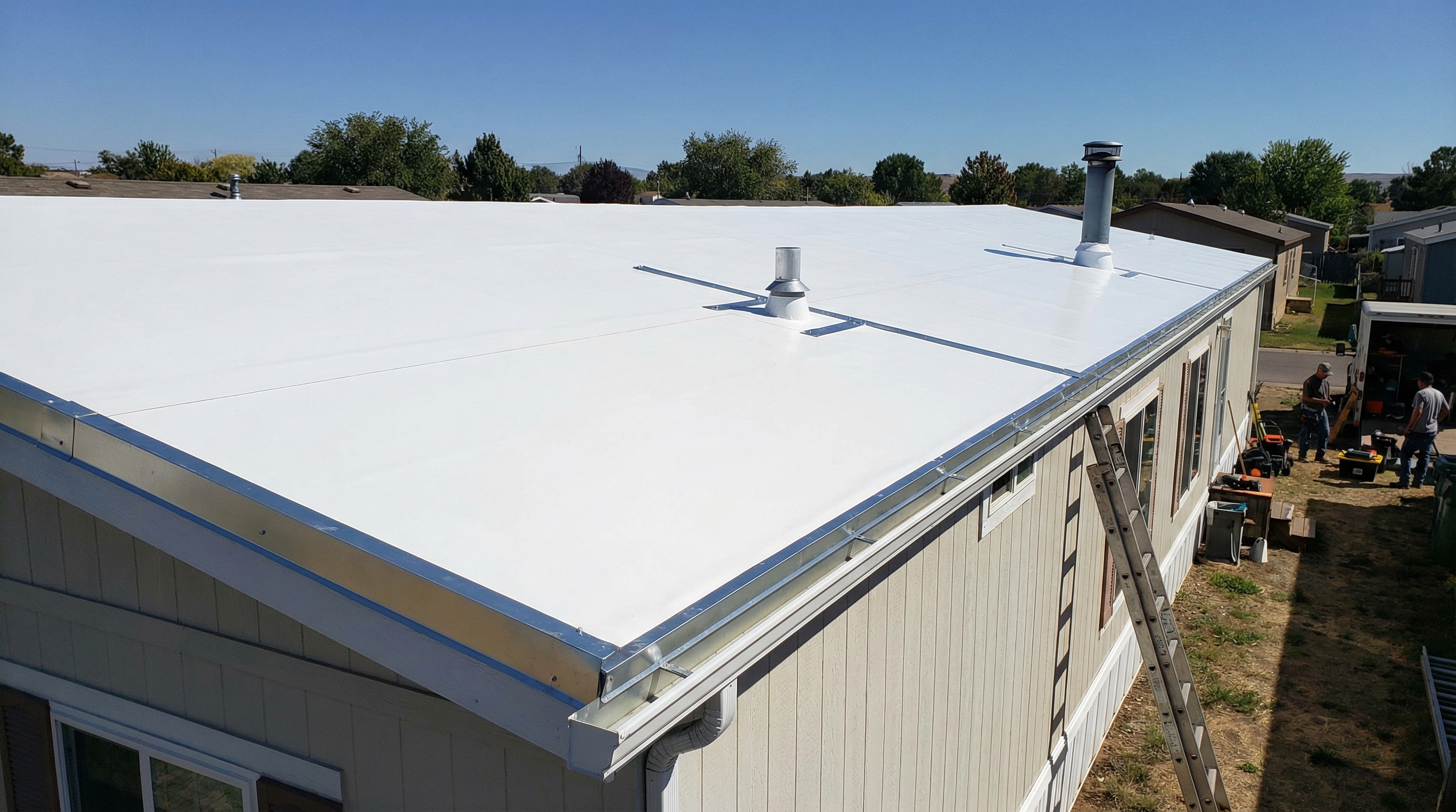 Completed TPO roof on mobile home showing clean white surface and proper flashing details