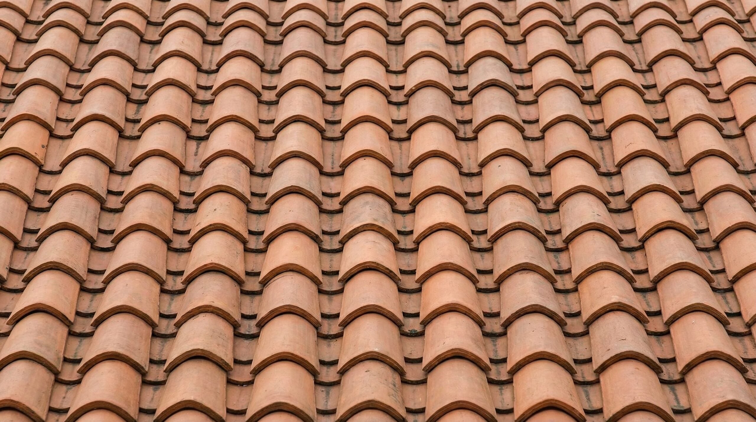 Close-up of properly installed clay tiles showing correct overlap and alignment patterns