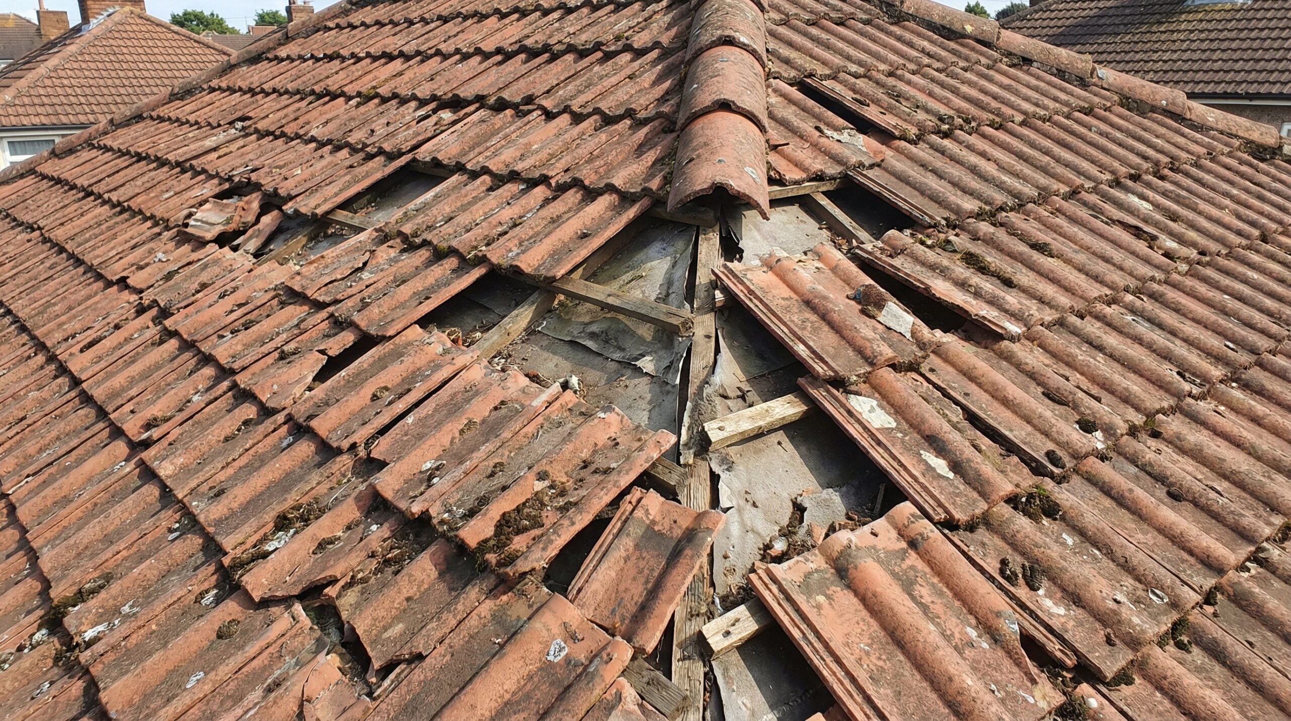 Cracked and missing tiles on residential roof