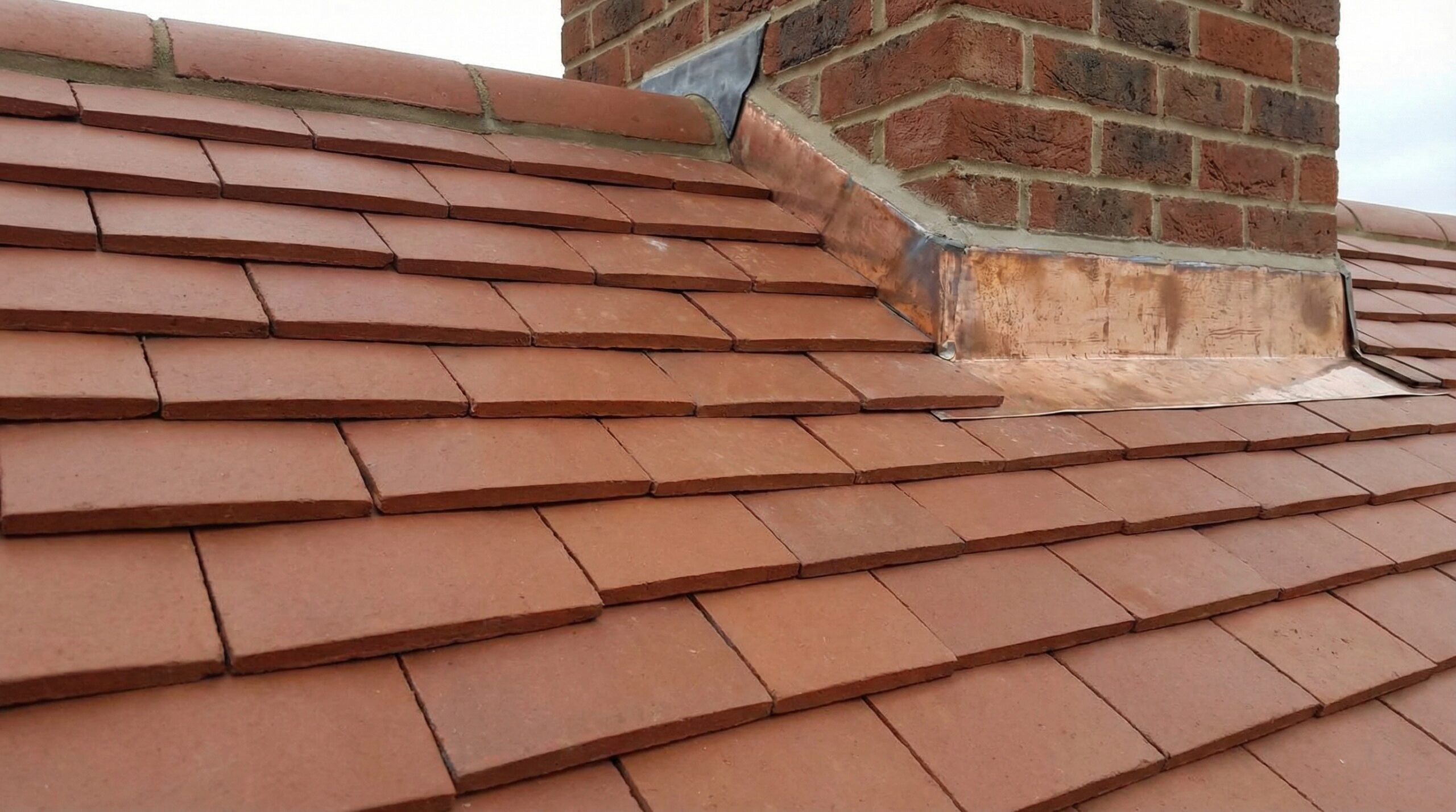 Close-up of properly installed tile showing correct overlap and flashing detail