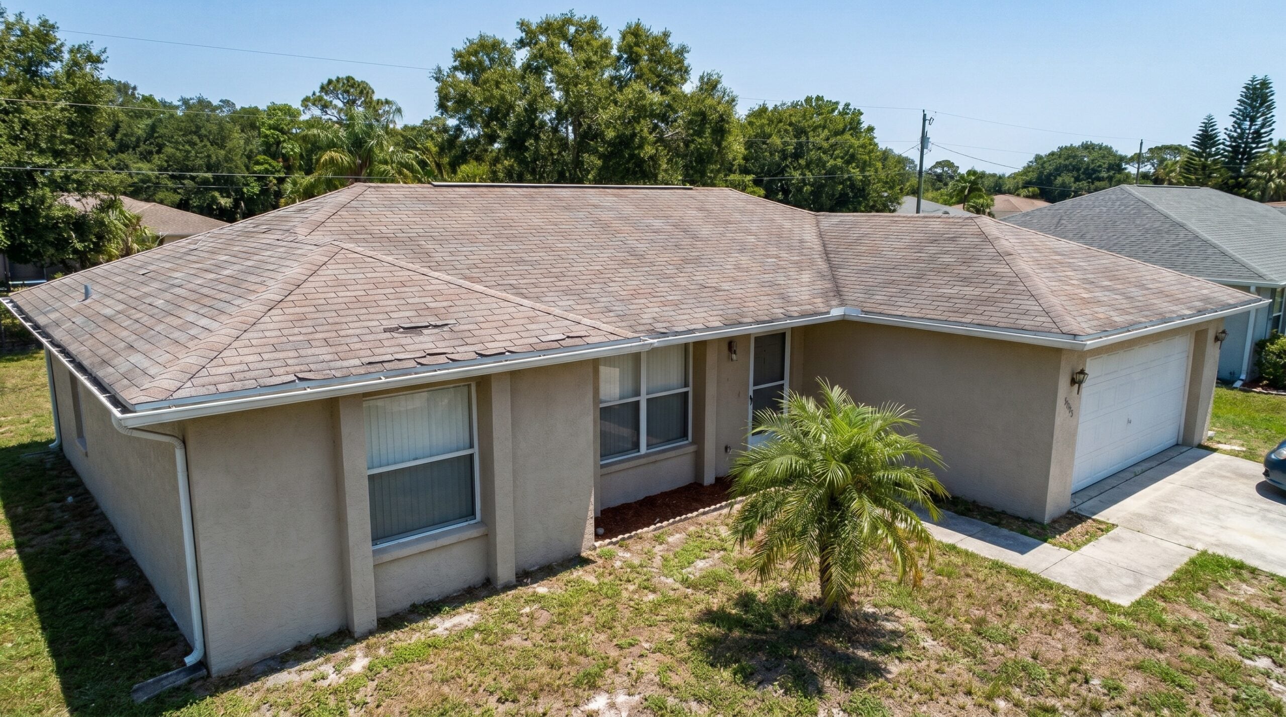 before and after photos showing Florida home transformation from asphalt shingles to composite slate tiles